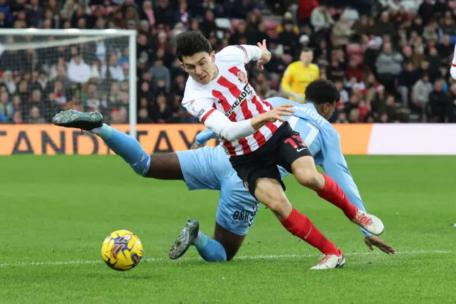 Luke O'Nien of Sunderland tackles Haji Wright of Coventry during to the Championship game between Sunderland AFC and Coventry City at The Stadium of Ligh