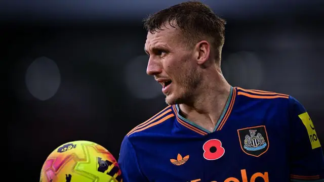 Dan Burn of Newcastle United holds the ball during the Premier League match between Brentford and Newcastle United 