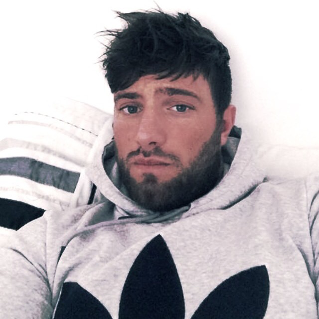 Harkins looking at the camera dressed in grey hoodie