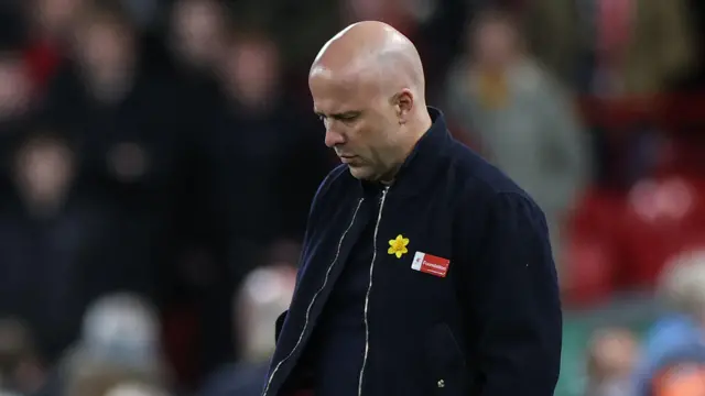 Arne Slot looks down dejected
