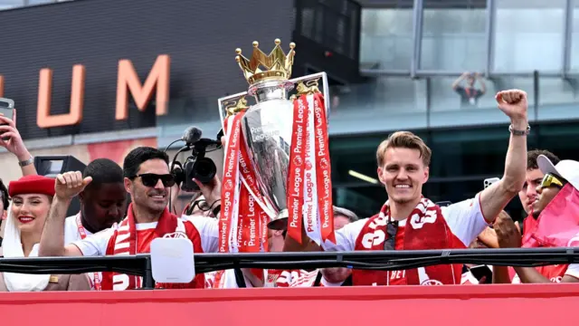 Mikel Arteta and Martin Odegaard celebrate with the Premier League trophy