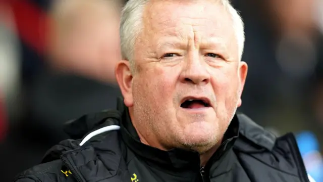 Chris Wilder stands on the touchline