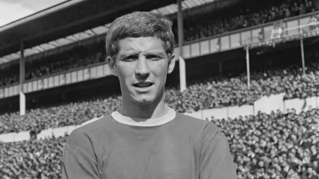 Black and white photo of Alan Ball Jr looking at the camera