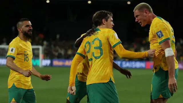 Lewis Miller celebrates with Australia team-mates