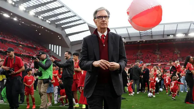 John Henry looks on, as Liverpool celebrate being crowned the Champions of the Premier League