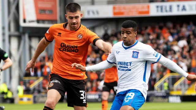 Dundee United's Declan Gallagher battles for possession with Rangers' Hamza Igamane