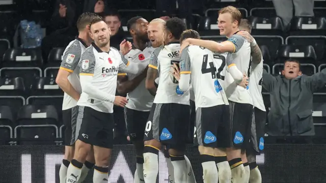 Derby County players gathering to celebrate Lars Jorgen-Salvesen's goal
