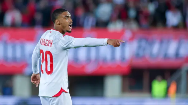 Yan Valery, wearing Tunisia's white kit with red accents, shouting directions during their match with Austria on 1 June