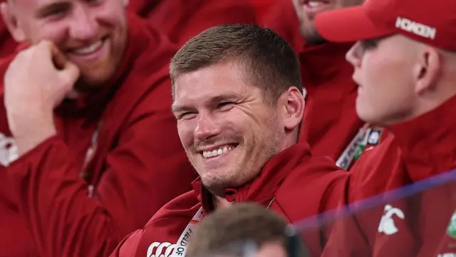 Owen Farrell smiles in the stands 