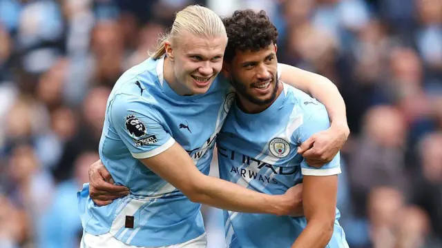 Erling Haaland celebrates scoring his team's fifth goal with teammate Matheus Nunes