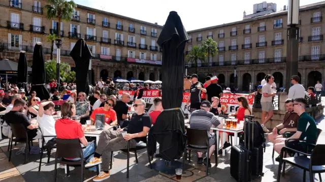 A large crowd of Manchester United fans take over the plaza