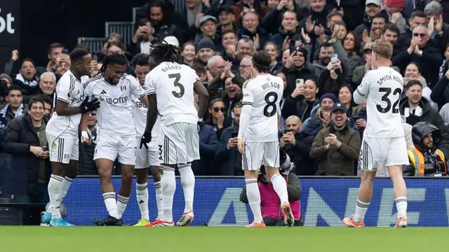 Alex Iwobi of Fulham celebrates with his teammates after scoring his side's second goal against Tottenham.