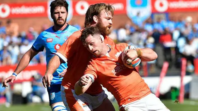 Magnus Bradbury is felled by a Bulls defender