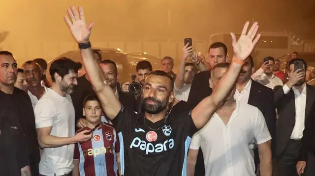 Mohamed Salah in a Trabzonspor shirt as fans watch on