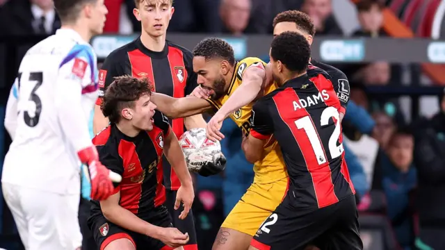 Matheus Cunha of Wolves clashes with Bournemouth's Milos Kerkez