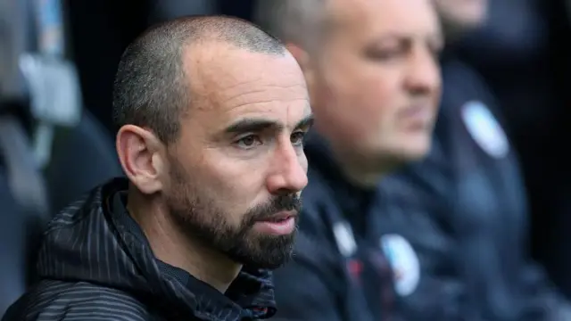 Leon Britton sat in the Swansea City dugout.