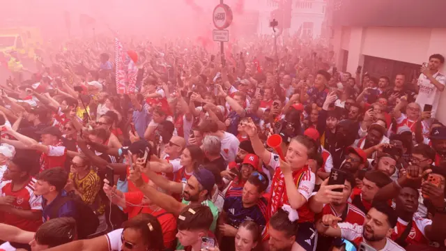 Arsenal supporters cheer their team 