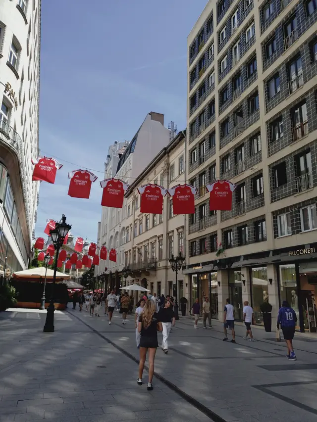 Arsenal shirts hanging over a street