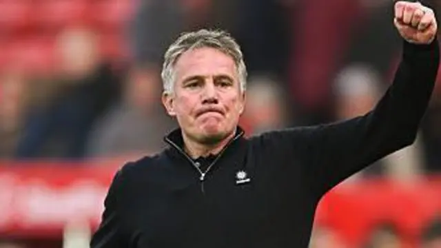 Boss Phil Parkinson raises his fist to acknowledge Wrexham's fans