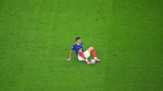 William Saliba sits on the turf