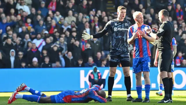 Jean-Philippe Mateta of Crystal Palace is fouled by Liam Roberts of Millwall