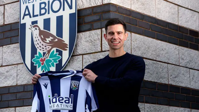 New West Brom boss Eric Ramsay photographed holding a West Brom shirt outside the club's training ground