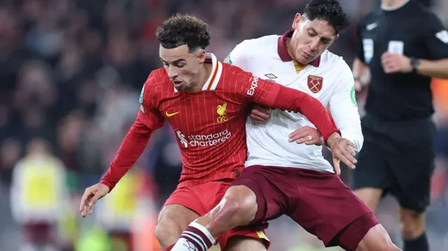 Liverpool's Curtis Jones challenges for the ball with Edson Alvarez of West Ham