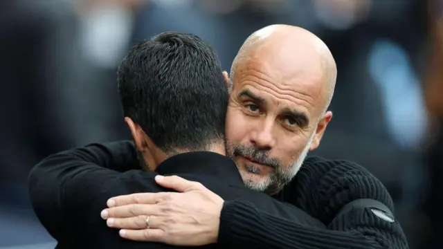 Mikel Arteta, Manager of Arsenal, embraces Josep Guardiola, Manager of Manchester City, prior to the Premier League match between Manchester City FC and Arsenal FC at Etihad Stadium