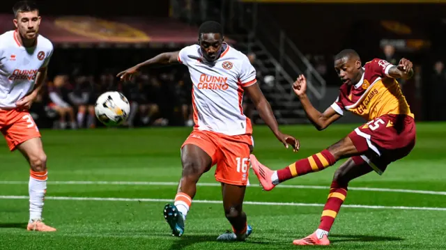 Motherwell's Tawanda Maswanhise has a shot blocked by Dundee United's Emmanuel Adegboyega