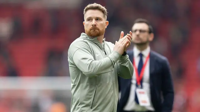 Calum McFarlane manager of Chelsea applauds the fans.