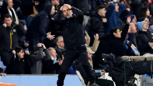 Pep Guardiola with his hands on his head
