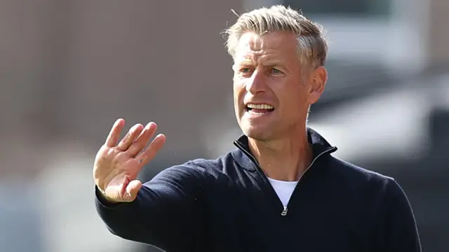 Newport County manager David Hughes instructs his players from the dugout at Grimsby