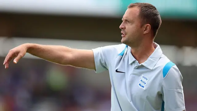 Chris Davies points his right arm as he issues instructions to his players during Saturday's pre-season friendly with Northampton Town