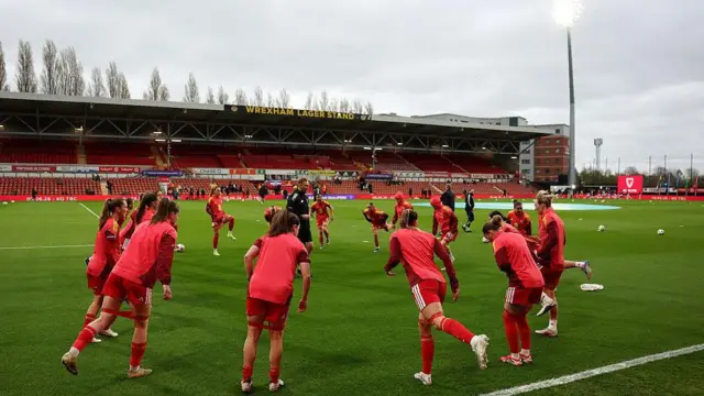 Wales women warming up on the Stok Cae Ras pitch