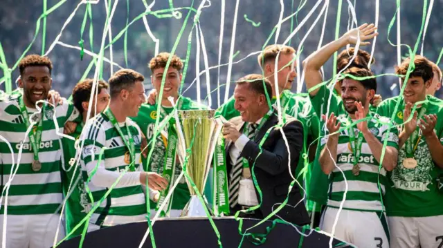 Brendan Rodgers and Celtic players celebrate with Premiership trophy