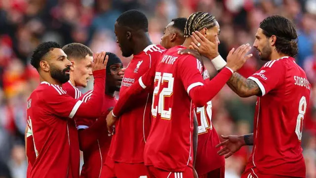 Liverpool players celebrate a goal