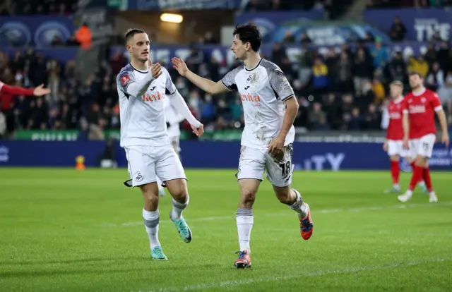 Swansea City players Jerry Yates and Charlie Patino celebrate a goal