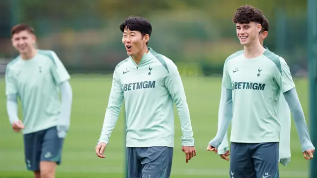 Son Heung-min smiles during a Tottenham training session