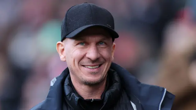 A close up of Bristol City boss Gerhard Struber wearing a black cap