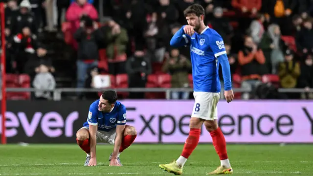 A photo of Portsmouth's Regan Poole and John Swift looking dejected after their loss to Bristol City