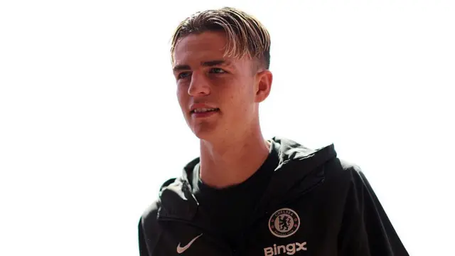 Jesse Derry walking into the stadium with a smile on his face playing for Chelsea