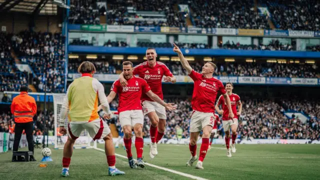 Chris Wood of Nottingham Forest celebrates with Nottingham Forest team-mates after scoring the opening goal against Chelsea