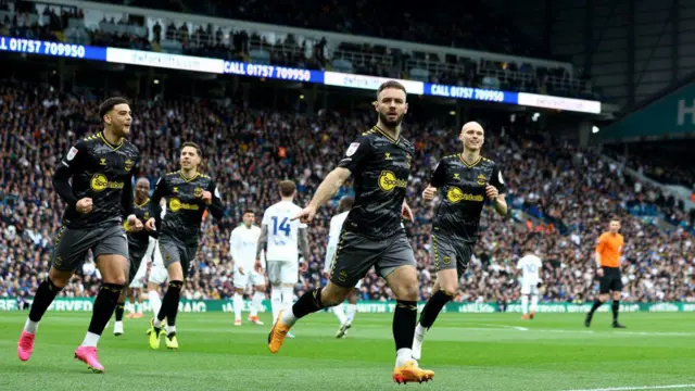 Adam Armstrong of Southampton celebrates with team mates Che Adams(L) and Will Smallbone(R) after opening the scoring during the Sky Bet Championship match between Leeds United and Southampton FC at Elland Road