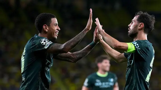 Savinho celebrates with Bernardo Silva after assisting Silva's goal