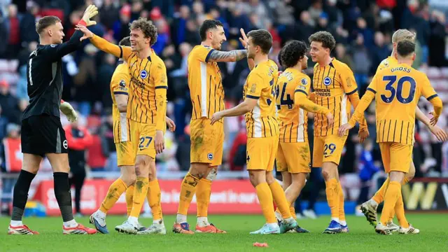 Brighton & Hove Albion players celebrate at the full time whistle
