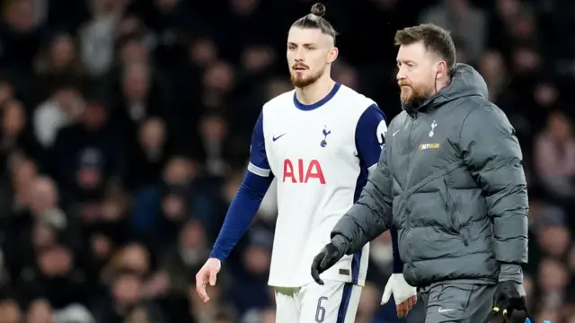 Radu Dragusin walks off the field injured