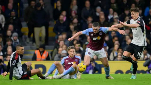 John McGinn battles for the ball with Tom Cairney