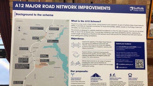 A picture of a noticeboard that shows the A12 improvement plan in full. A map of the plans can be seen along with information about what the scheme is, the objectives and the proposal.