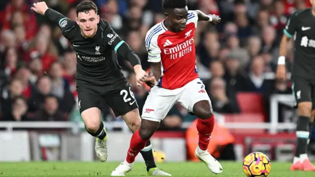 Andy Robertson chases Bukayo Saka