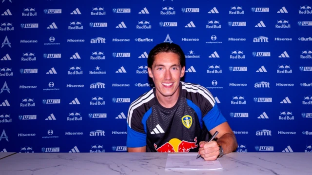 Harry Wilson poses for photos as he signs his new Leeds contract